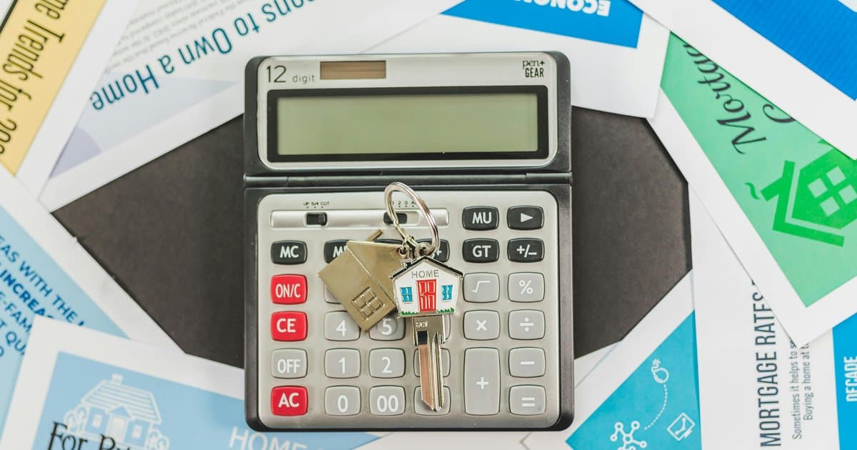 Calculator with house keys on mortgage rate documents