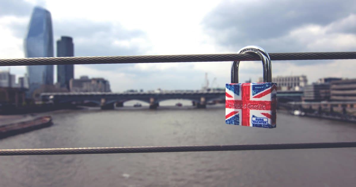 Union Jack padlock on London bridge over Thames River