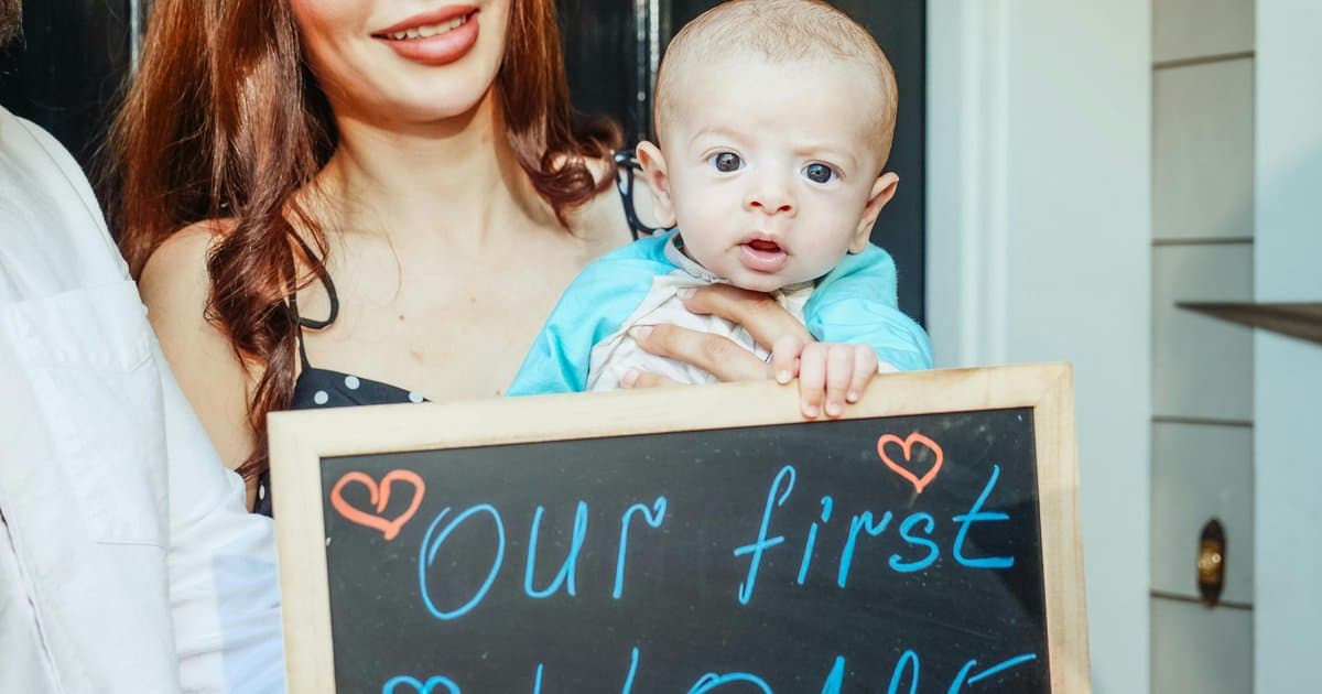 Young family celebrating first home purchase with baby