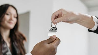 Real estate agent handing keys to new homeowner