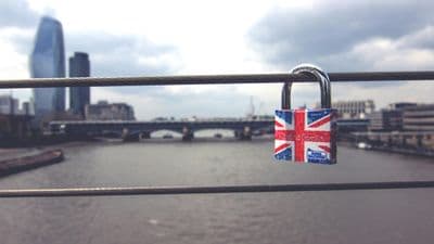 Union Jack padlock on London bridge over Thames River